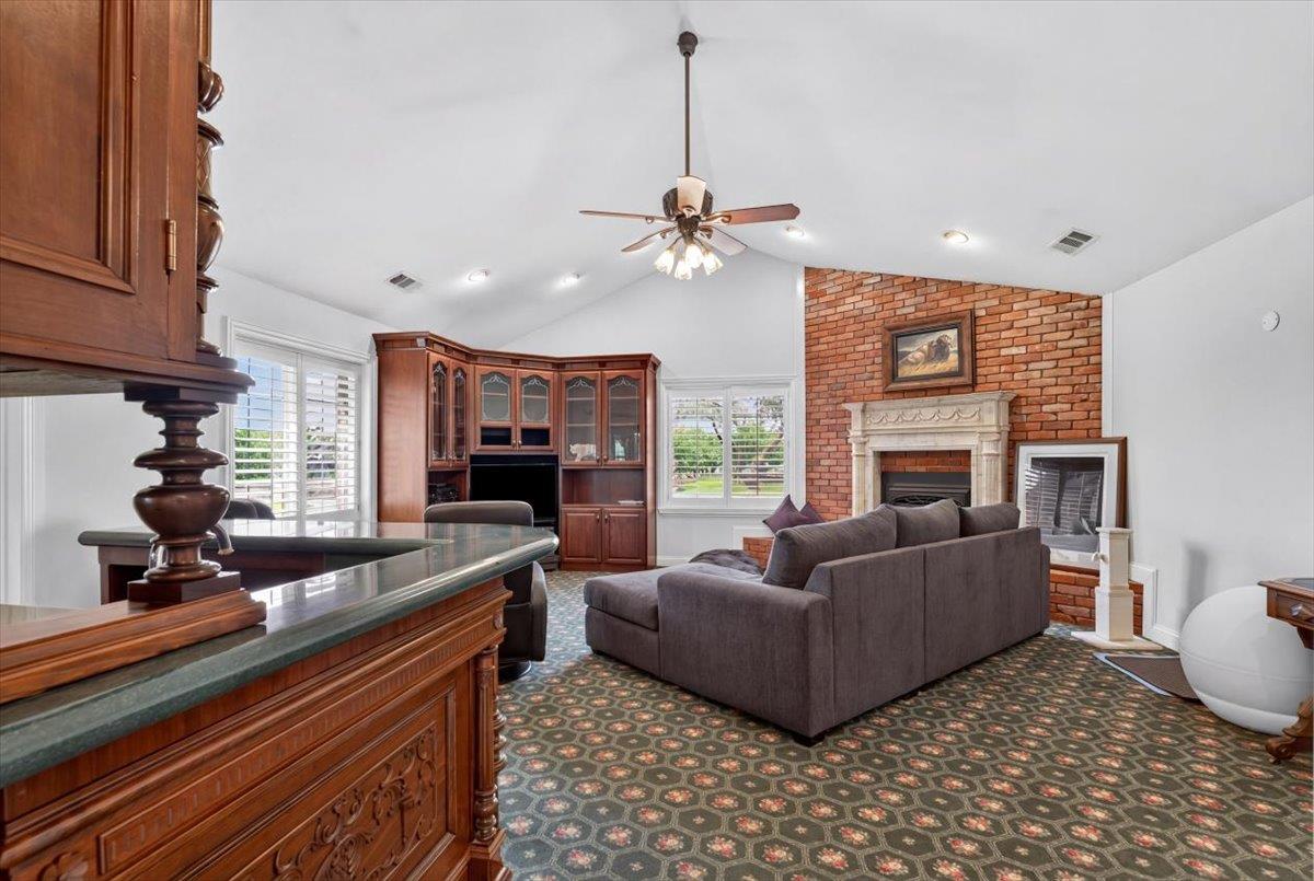 30324 Lone Tree Road Oakdale, CA 95361 - Photo 12 of 74 a living room with furniture a fireplace and a chandelier