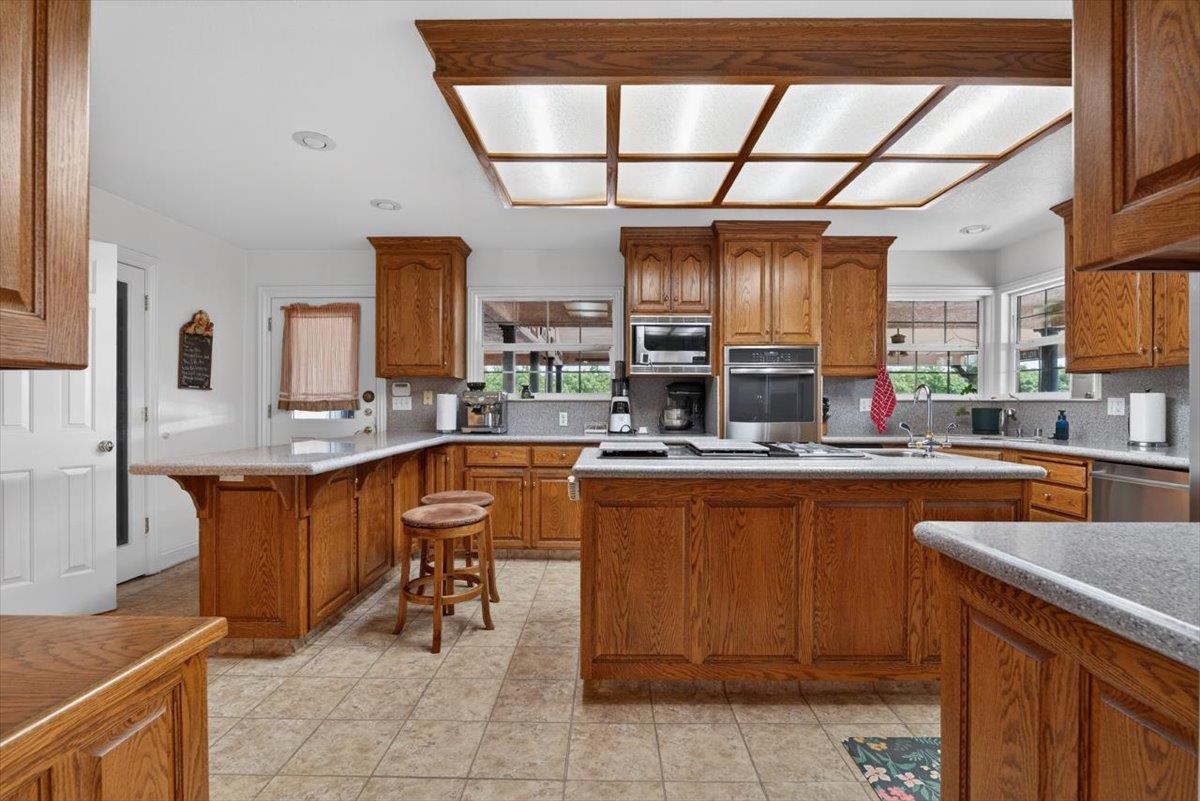 30324 Lone Tree Road Oakdale, CA 95361 - Photo 15 of 74 a kitchen with stainless steel appliances granite countertop a sink and cabinets