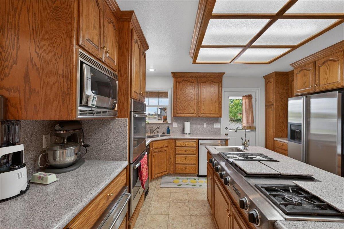 30324 Lone Tree Road Oakdale, CA 95361 - Photo 16 of 74 a kitchen with stainless steel appliances granite countertop a stove and a sink