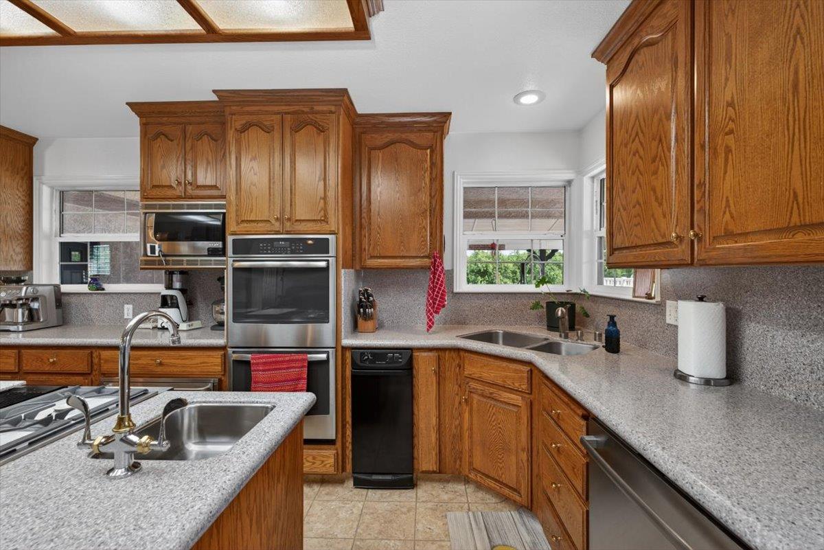 30324 Lone Tree Road Oakdale, CA 95361 - Photo 17 of 74 a kitchen with stainless steel appliances granite countertop a sink stove and cabinets