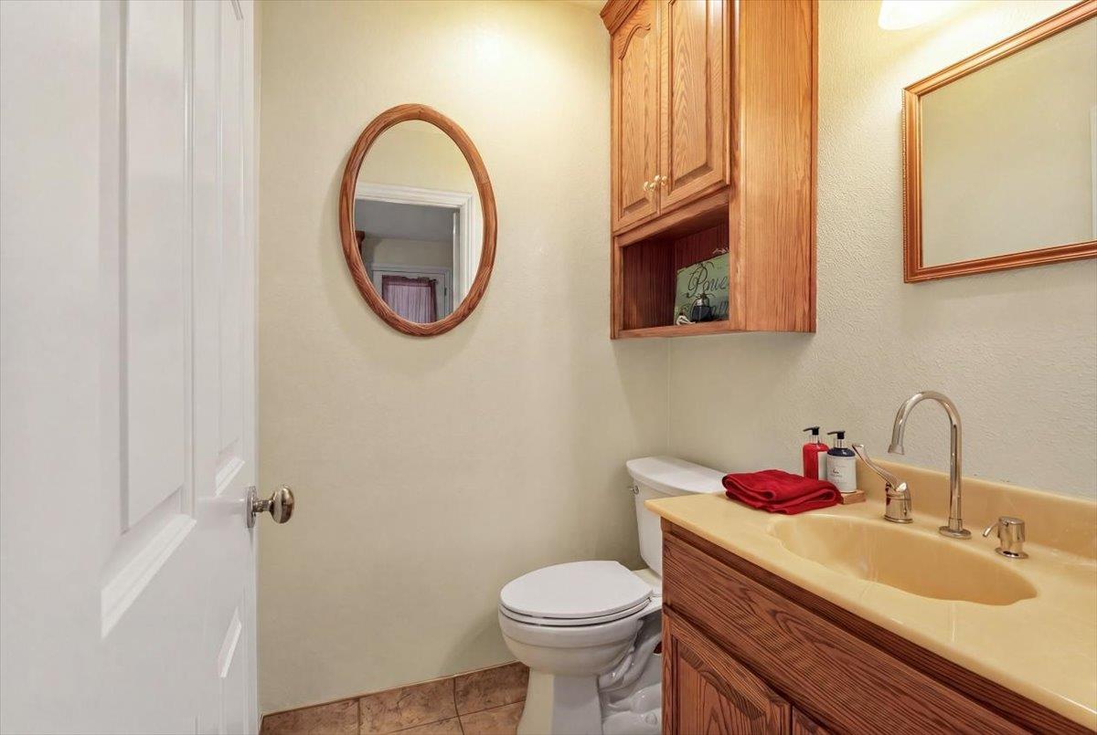 30324 Lone Tree Road Oakdale, CA 95361 - Photo 21 of 74 a bathroom with a toilet sink and mirror
