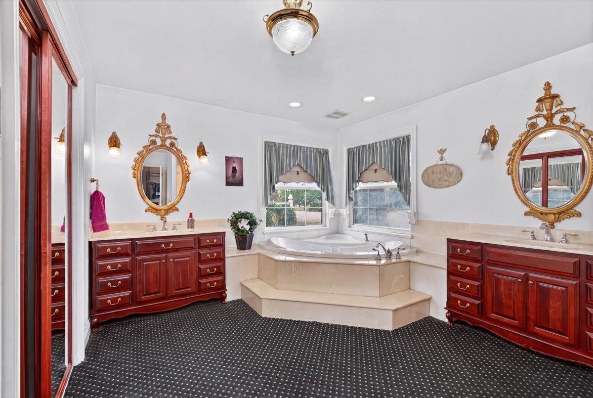 30324 Lone Tree Road Oakdale, CA 95361 - Photo 27 of 74 a living room with furniture a mirror and a chandelier