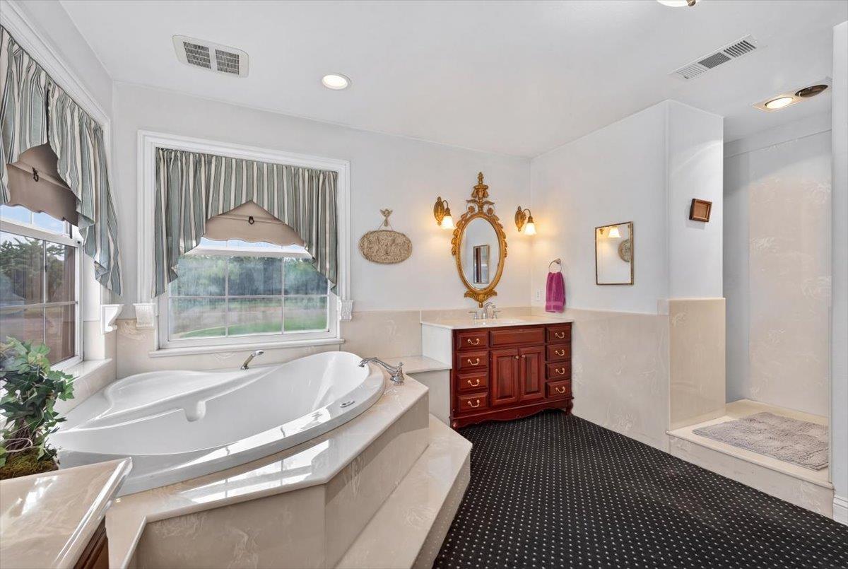 30324 Lone Tree Road Oakdale, CA 95361 - Photo 28 of 74 a spacious bathroom with a tub and a shower