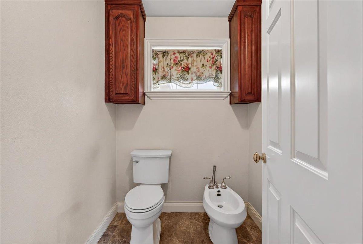 30324 Lone Tree Road Oakdale, CA 95361 - Photo 29 of 74 a white toilet sitting next to a small bathroom