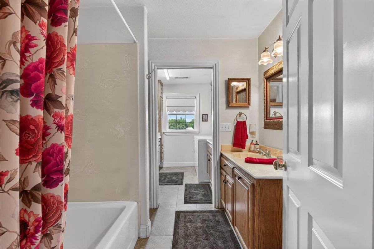 30324 Lone Tree Road Oakdale, CA 95361 - Photo 32 of 74 a bathroom with a bathtub sink and mirror