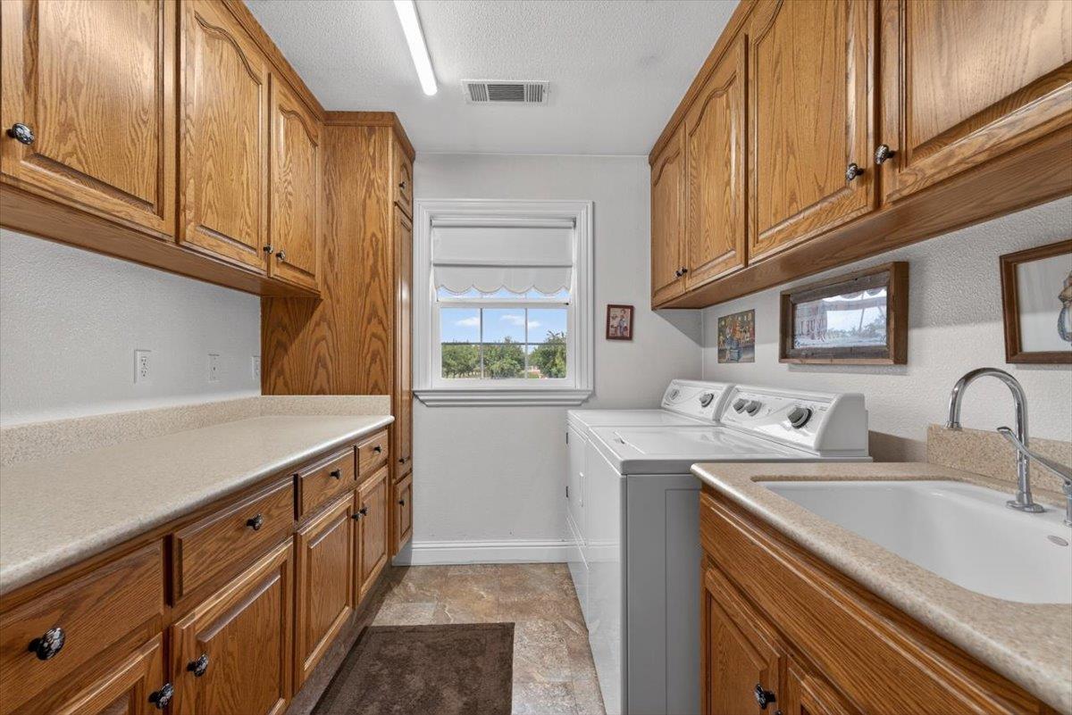 30324 Lone Tree Road Oakdale, CA 95361 - Photo 34 of 74 a kitchen with stainless steel appliances granite countertop a sink a stove and cabinets