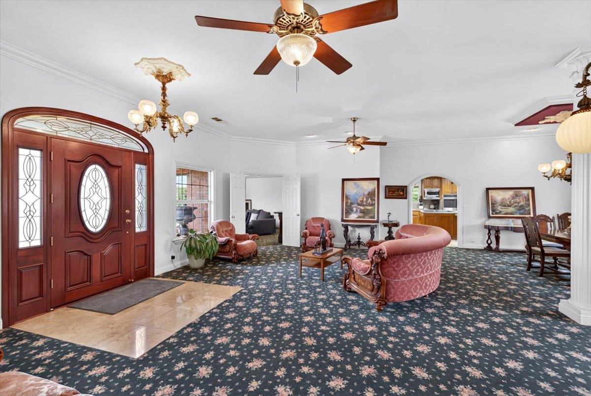 30324 Lone Tree Road Oakdale, CA 95361 - Photo 4 of 74 a living room with furniture a chandelier and a rug
