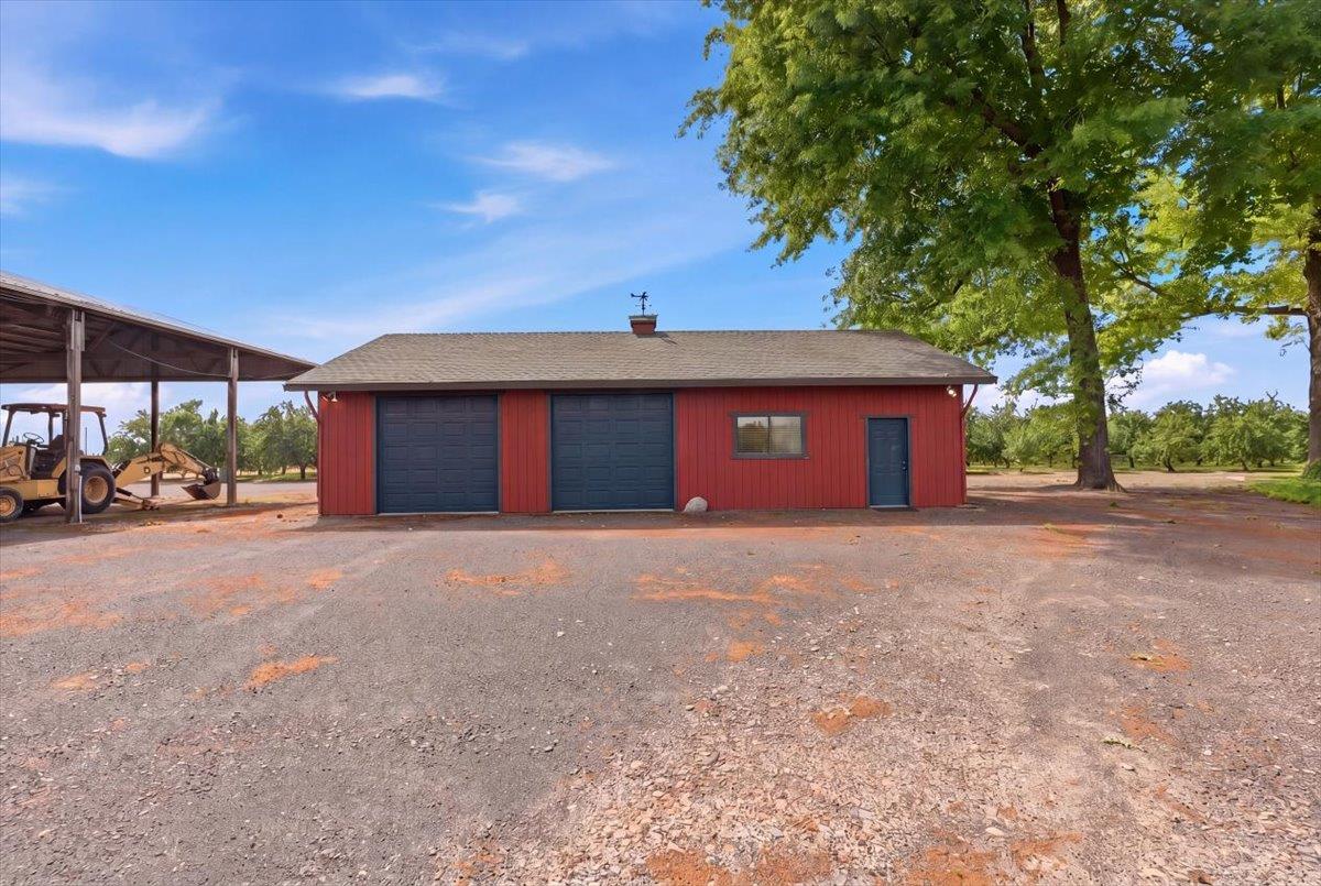 30324 Lone Tree Road Oakdale, CA 95361 - Photo 47 of 74 a front view of a house with a yard and garage