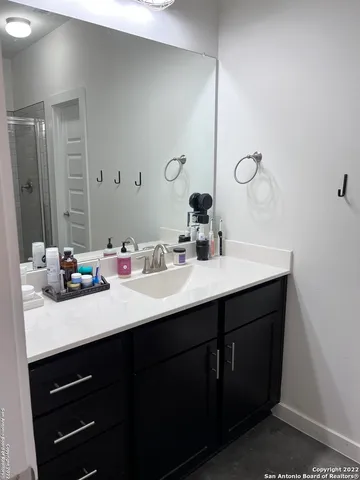 a bathroom with a double vanity sink and a mirror