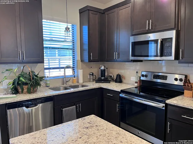 a kitchen with a sink stove and microwave