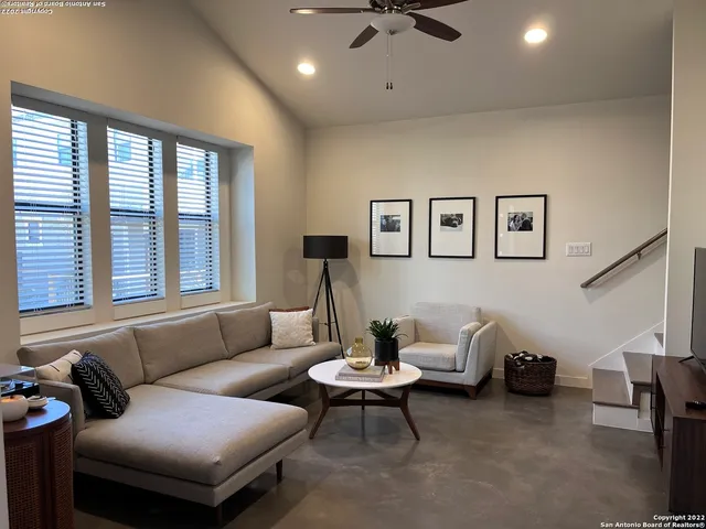 a living room with furniture and a large window