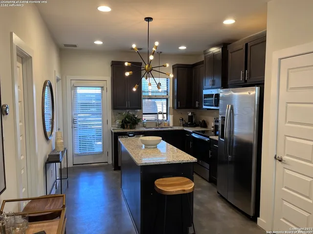 a kitchen with granite countertop stainless steel appliances and wooden cabinets