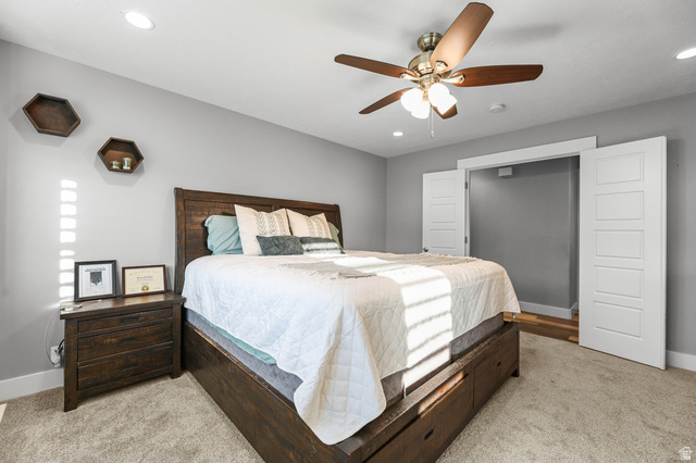 2056 West Ridgeline Road Stockton, UT 84071 - Photo 20 of 50 Carpeted bedroom featuring recessed lighting, a ceiling fan with integrated lighting, and a closet with bifold doors