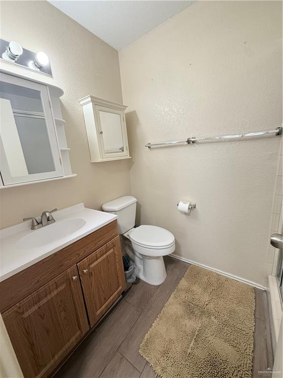 807 East 21st Street, Unit 8 Mission, TX 78572 - Photo 11 of 15 a bathroom with a toilet sink and mirror