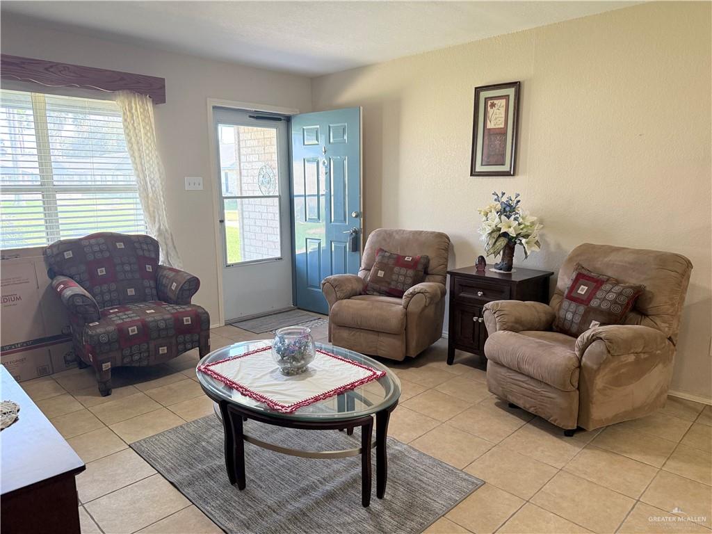 807 East 21st Street, Unit 8 Mission, TX 78572 - Photo 4 of 15 a living room with furniture a table and a large window