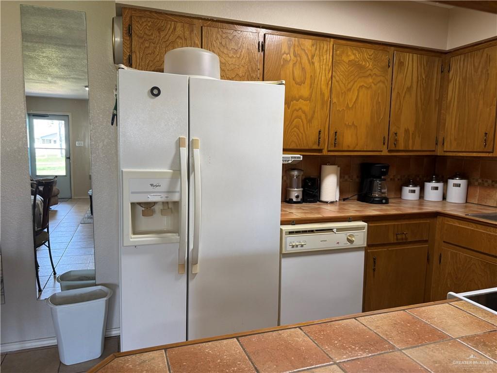 807 East 21st Street, Unit 8 Mission, TX 78572 - Photo 7 of 15 a kitchen with a refrigerator and cabinets