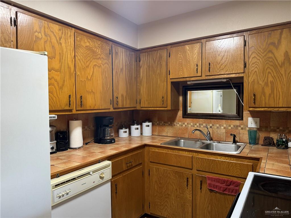 807 East 21st Street, Unit 8 Mission, TX 78572 - Photo 8 of 15 a kitchen with a sink and a refrigerator