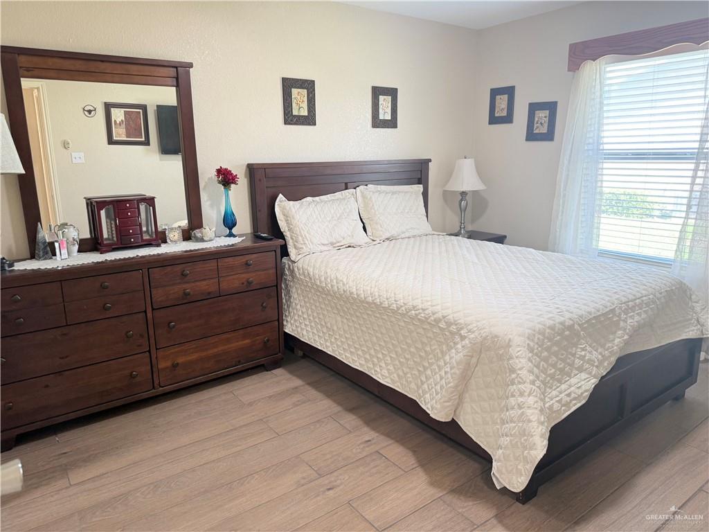 807 East 21st Street, Unit 8 Mission, TX 78572 - Photo 9 of 15 a bedroom with a bed and a dresser