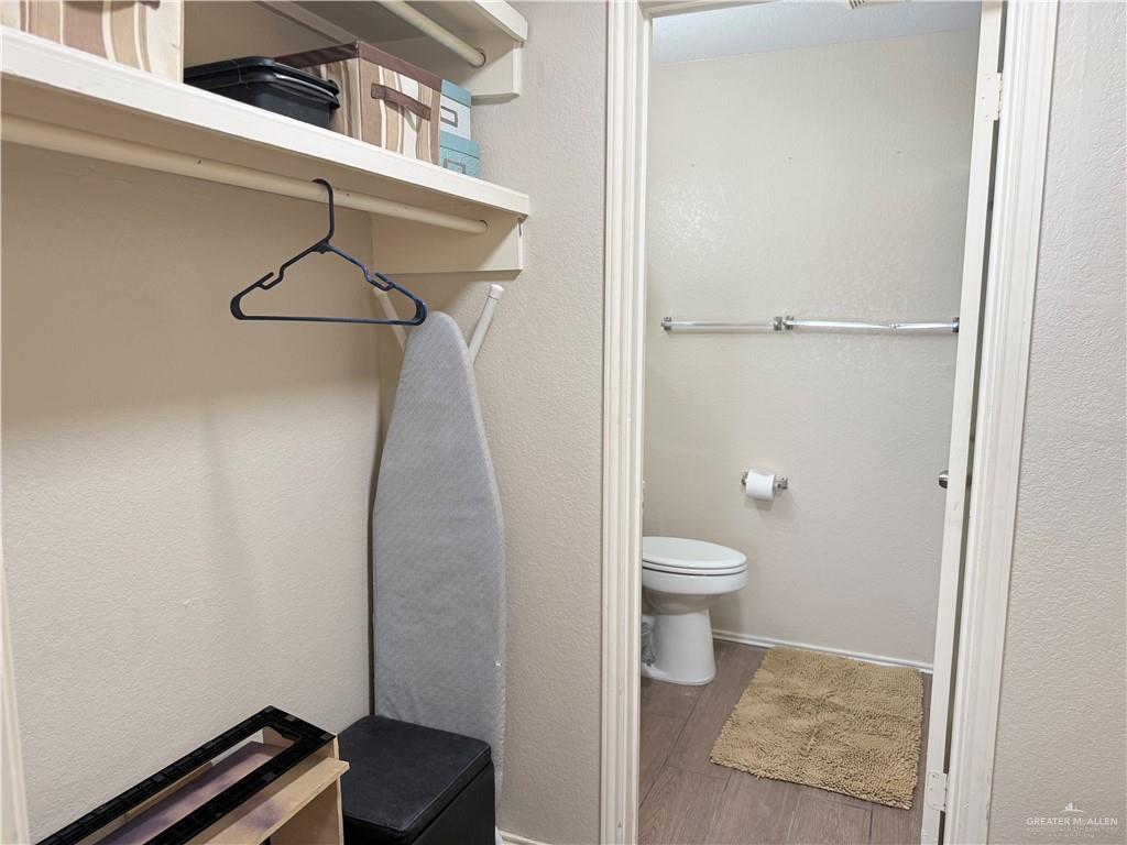 807 East 21st Street, Unit 8 Mission, TX 78572 - Photo 10 of 15 a bathroom with a granite countertop shower and a toilet
