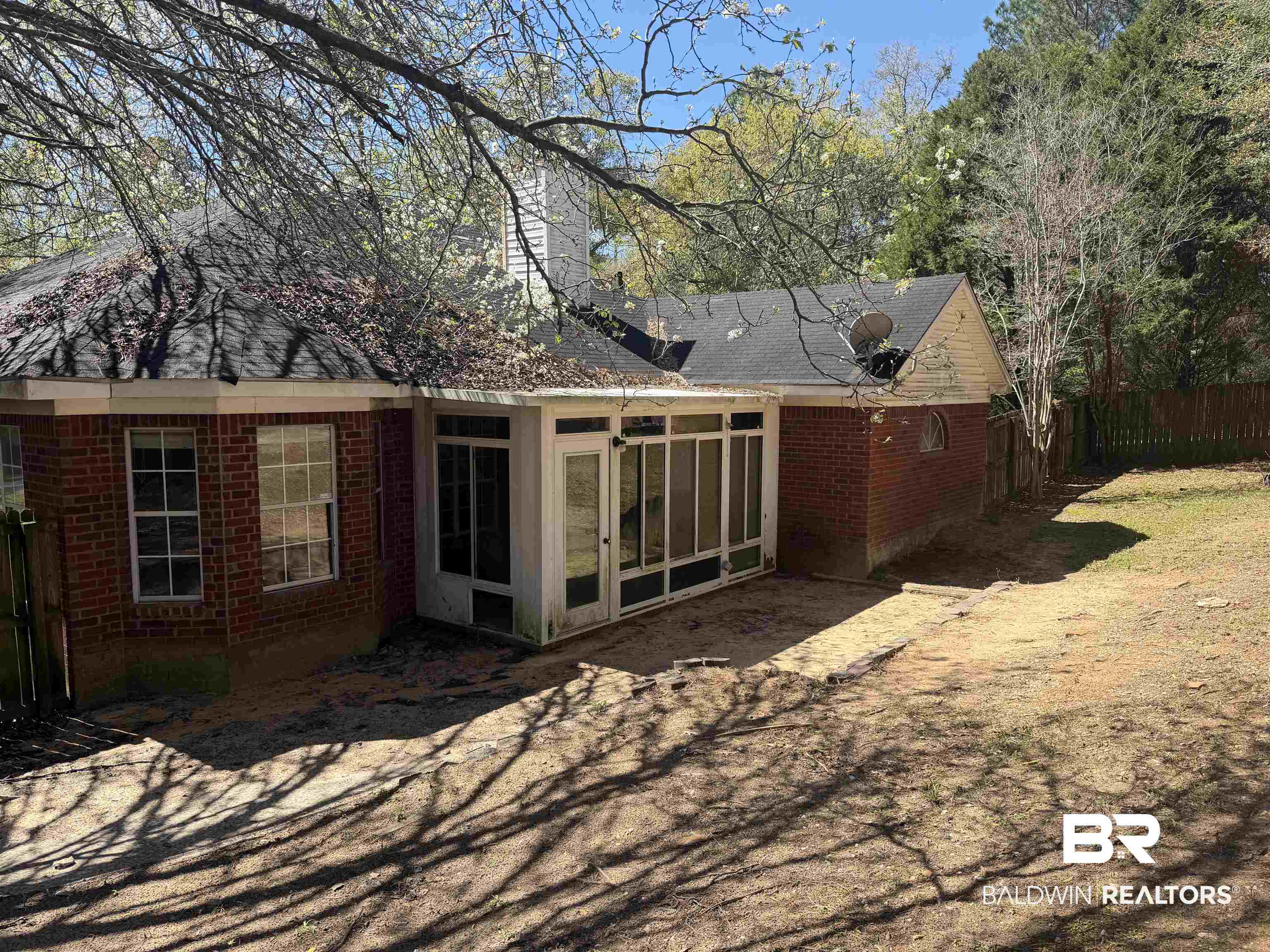 7067 Pinehill Road Daphne, AL 36526 - Photo 6 of 18 Rear view of house with brick siding, a sunroom, a chimney, and roof with shingles