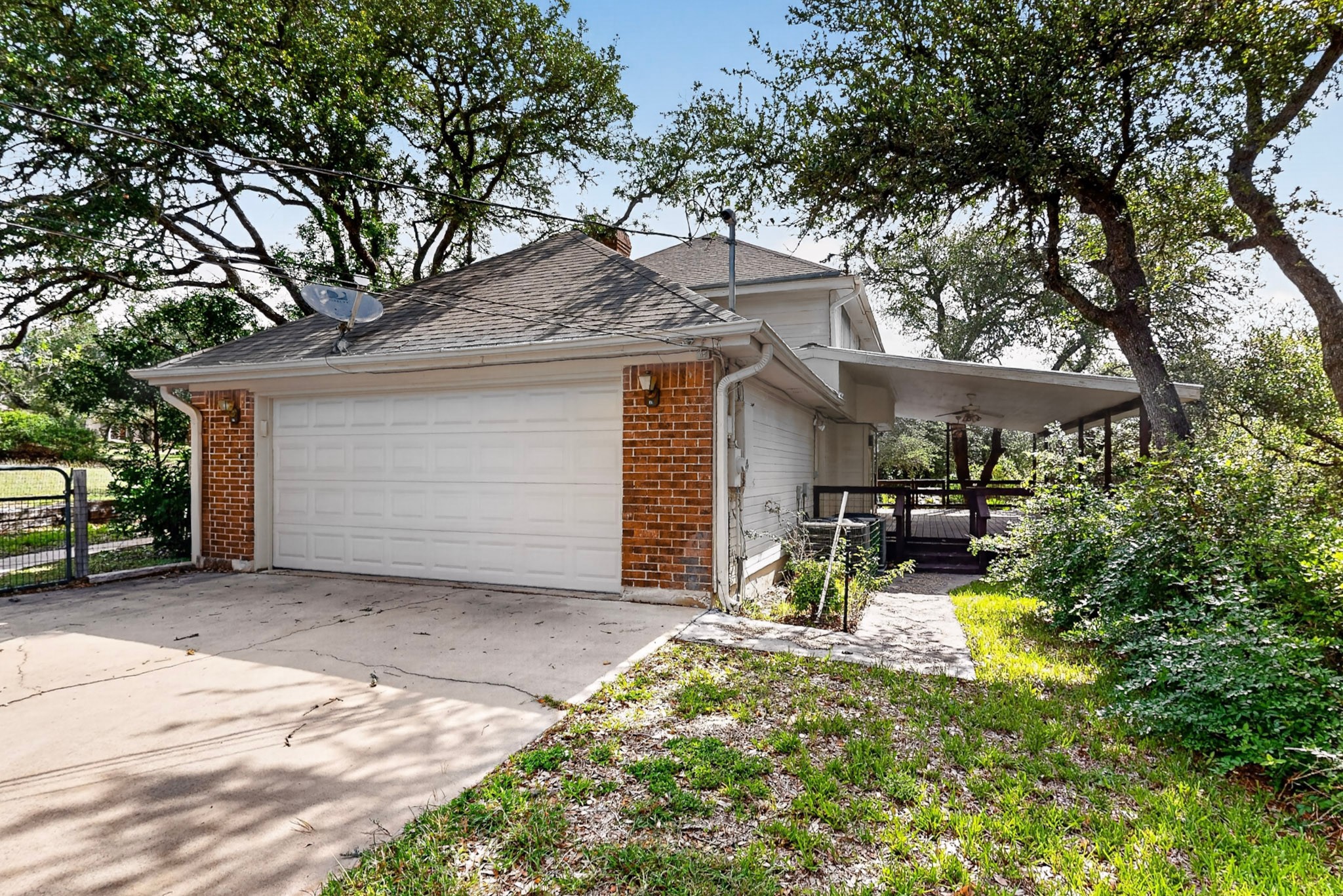 1003 Pier Branch Road Dripping Springs, TX 78620 - Photo 31 of 40 A private driveway leads to a spacious attached garage with ample parking.