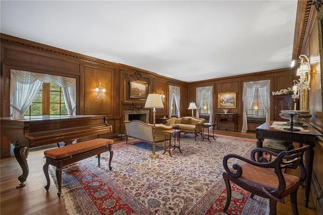 a living room with furniture a rug and a large window