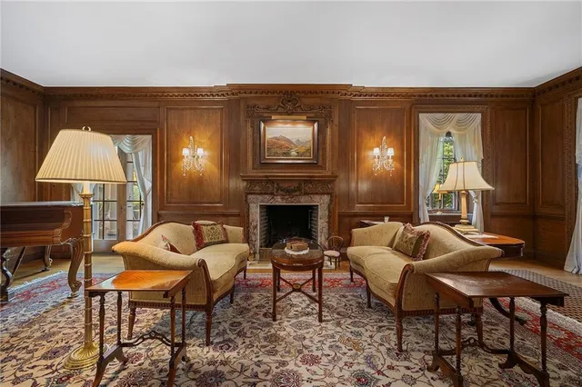 a living room with furniture and a fireplace