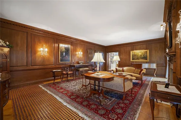 a living room with furniture a rug and a large window