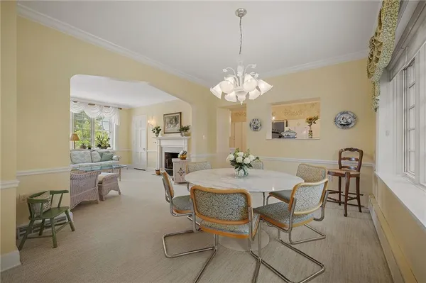 a view of a dining room with furniture and chandelier