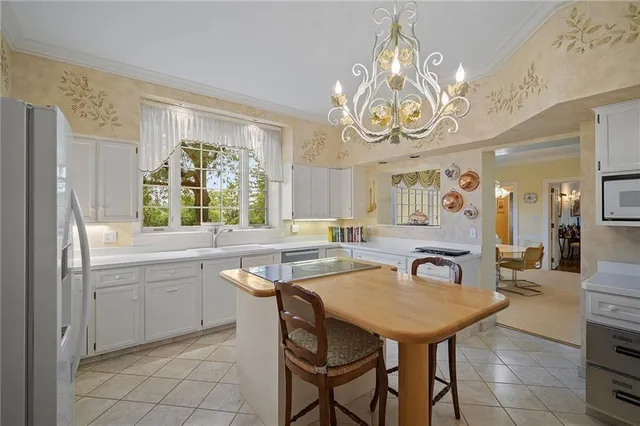 a kitchen with a table and chairs in it