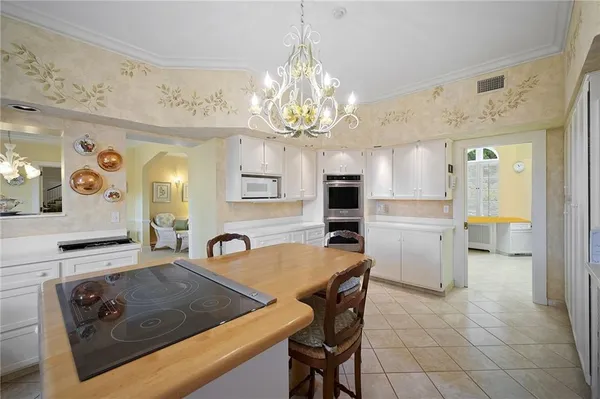 a view of a kitchen area kitchen island dining table and chairs