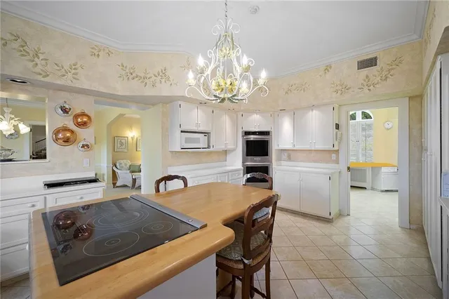 a view of a kitchen area kitchen island dining table and chairs