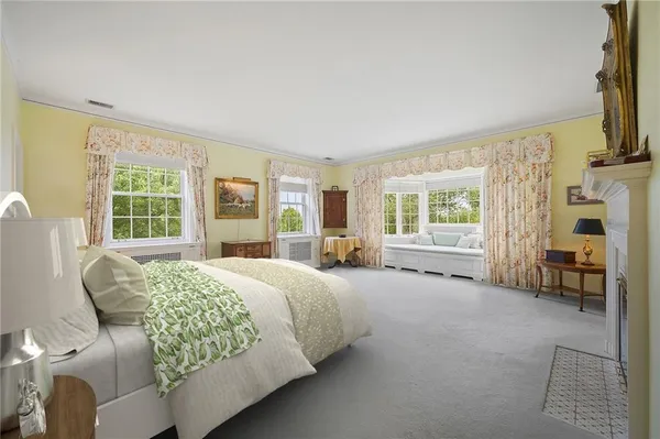 a bedroom with a bed chair and a window