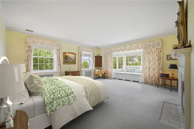 a bedroom with a bed chair and a window