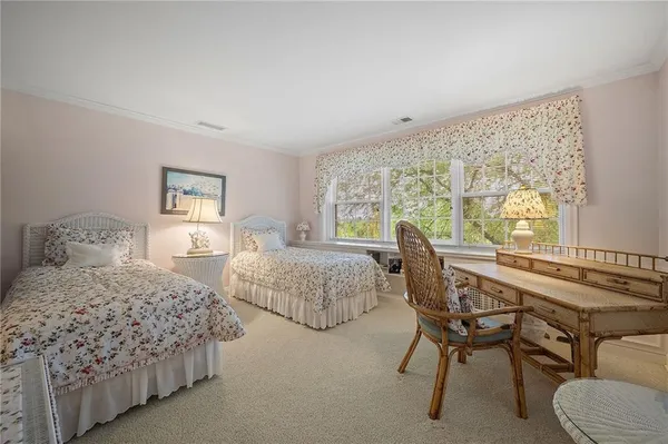 a bedroom with two beds and a large window