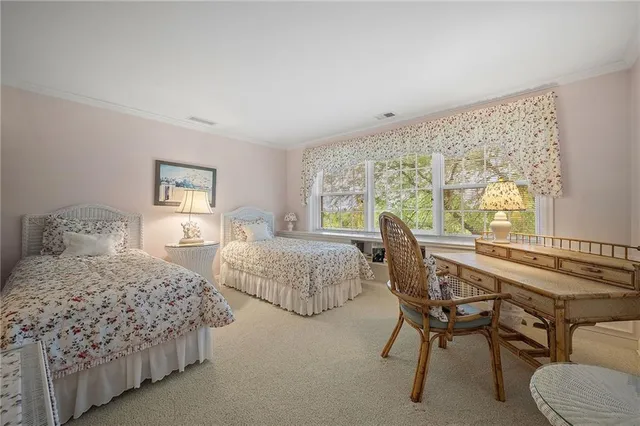 a bedroom with two beds and a large window