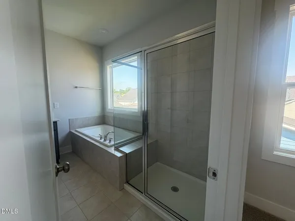 a bathroom with a shower a mirror and a sink