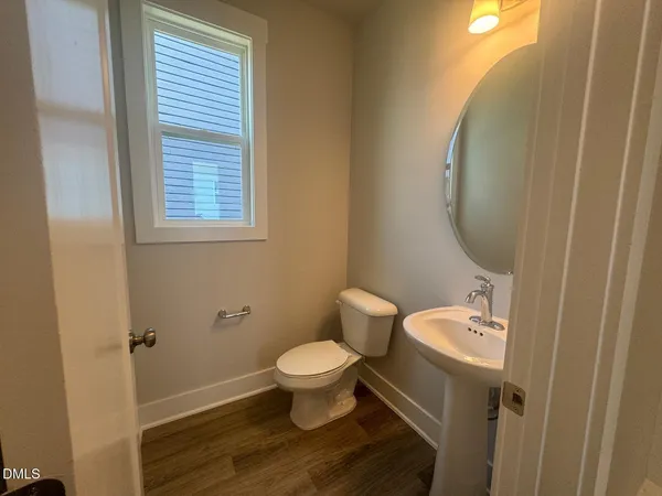 a bathroom with a toilet and a mirror