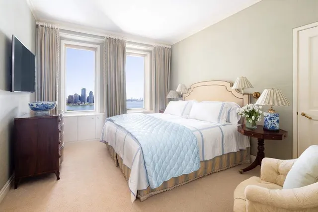 a spacious bathroom with a granite countertop tub a double vanity sink and a large mirror