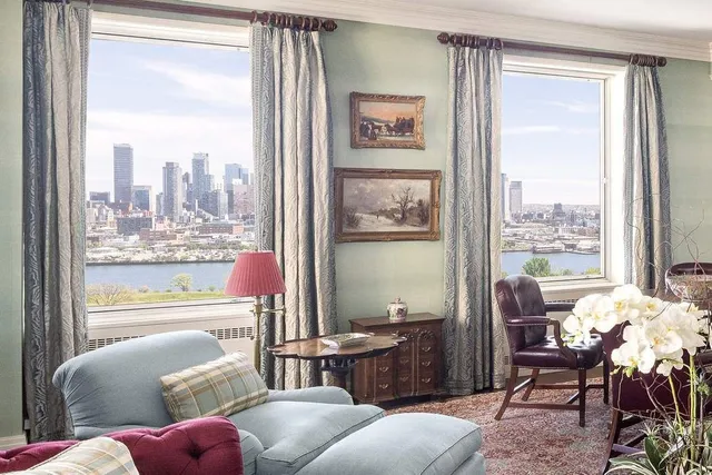 a dining room with furniture window and wooden floor