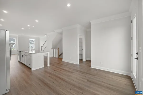 a view of kitchen and hall with wooden floor