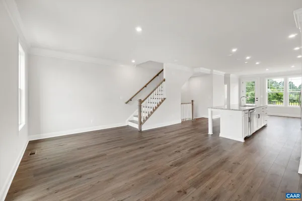 a view of a kitchen with wooden floor and stairs