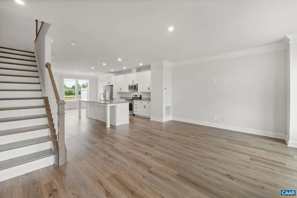 a view of kitchen with cabinets and wooden floor