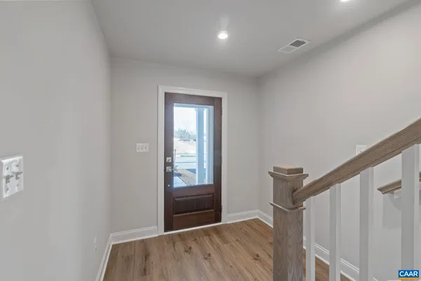 a view of hallway with a closet and mirror