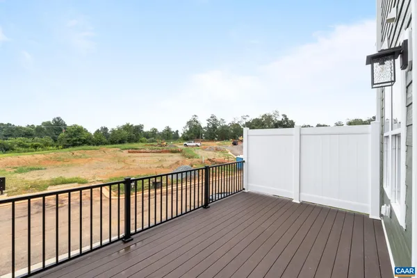 a view of a balcony with wooden floor and lake view