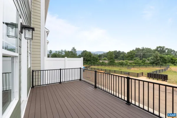 a view of a roof deck with wooden floor and fence