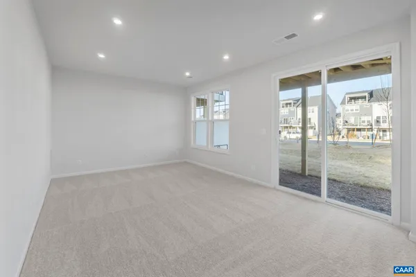 a view of an empty room with glass door