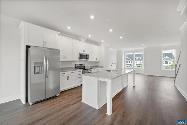 a kitchen with white cabinets and stainless steel appliances