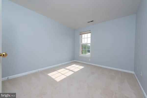 a view of an empty room and a window