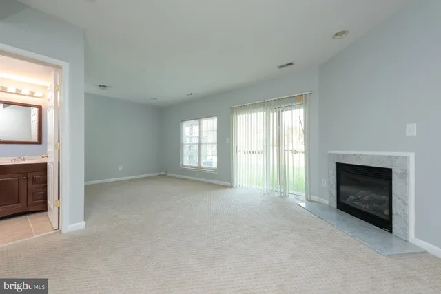 a view of empty room with a fireplace